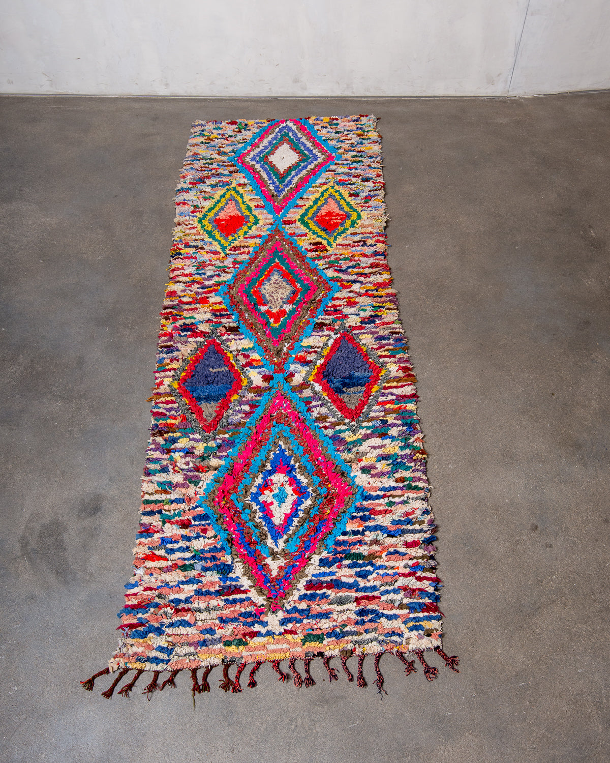 Modern designer vintage handcrafted Berber rug from Morocco. Boucherouite runner rug with beautiful colors and patterns.
